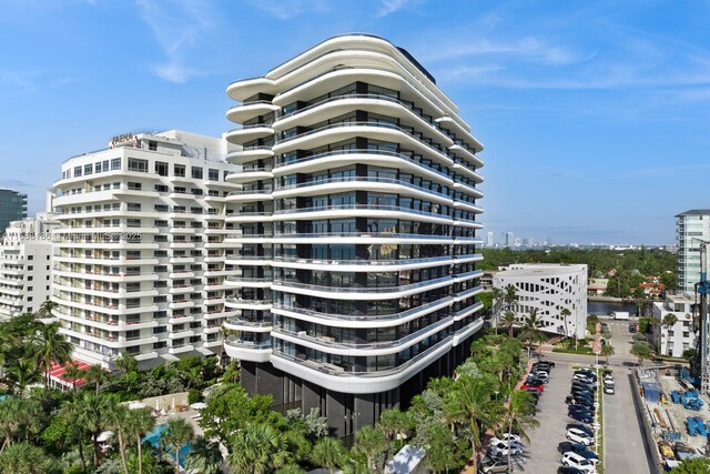 balcony featuring a water view and a view of the beach