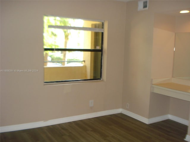 empty room featuring dark wood-type flooring