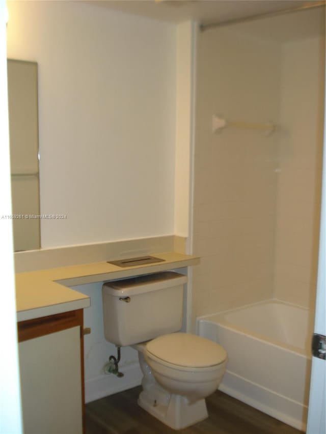 full bathroom with tub / shower combination, vanity, toilet, and wood-type flooring