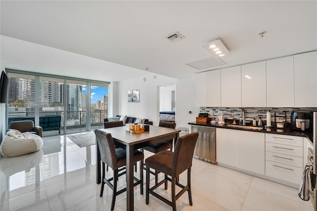 dining room featuring a view of city, visible vents, and marble finish floor