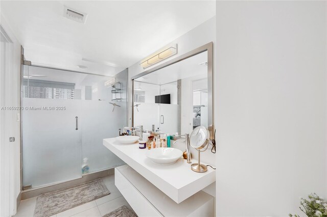 bathroom featuring tile patterned floors, vanity, and an enclosed shower