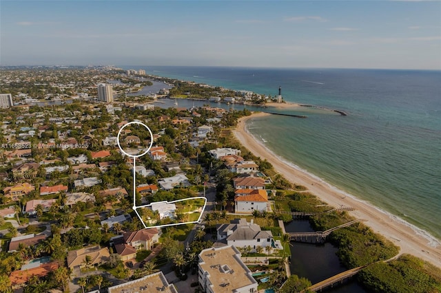 aerial view with a water view, a residential view, and a view of the beach