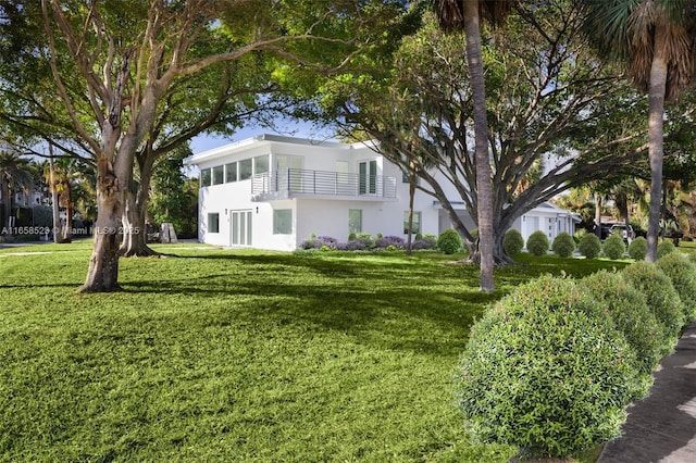 exterior space featuring a front lawn and stucco siding