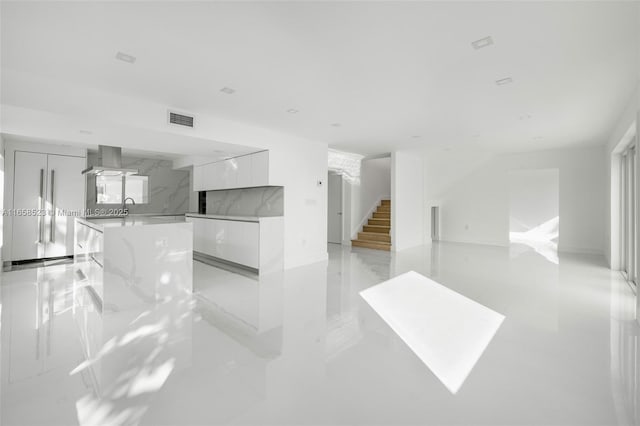 living room featuring marble finish floor, stairs, and visible vents