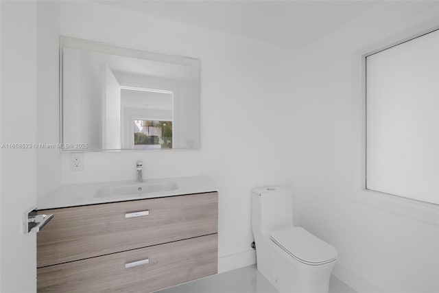 bathroom with toilet and vanity