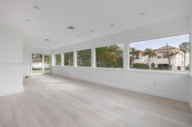 unfurnished sunroom with visible vents