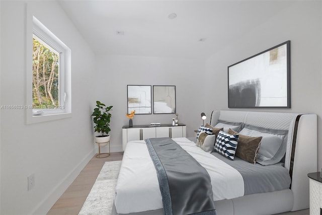 bedroom featuring light wood-type flooring and baseboards