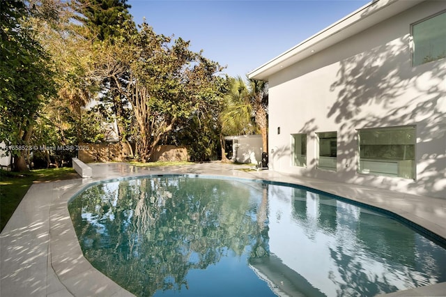 view of pool with a patio area, fence, and a fenced in pool