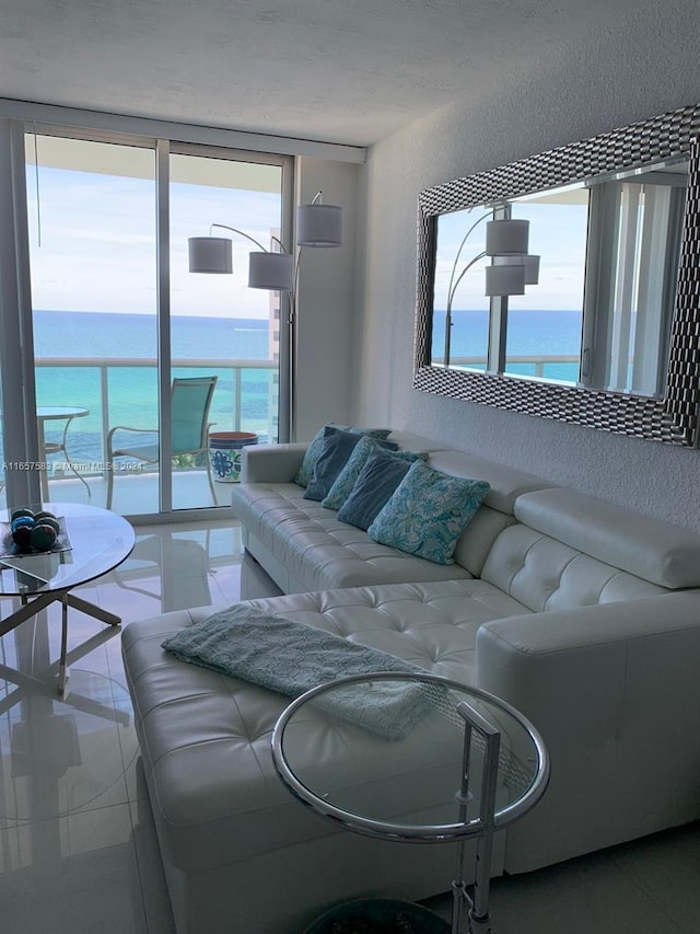 living room with a water view and tile patterned flooring