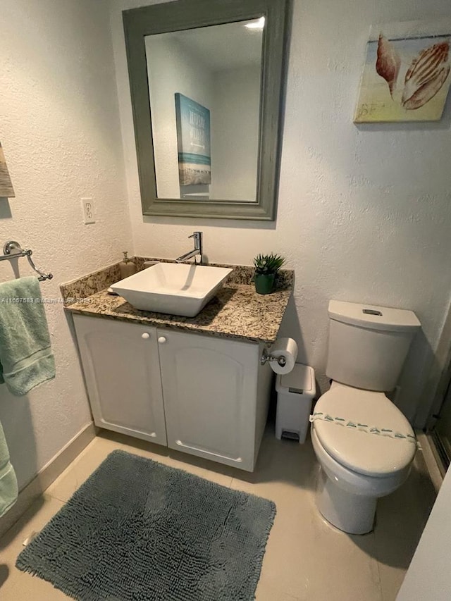 bathroom featuring toilet and vanity