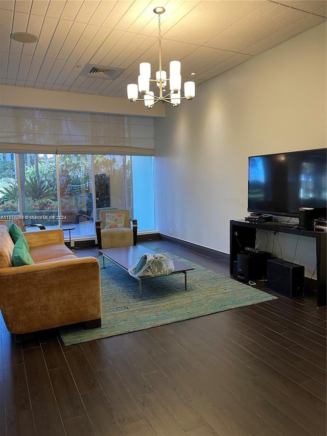 living room with dark wood-type flooring and a chandelier