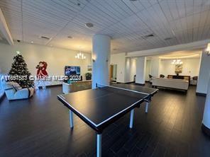 3801 S Ocean Dr Unit 12M, Hollywood, FL 33019 - rec room featuring a chandelier and wood finished floors