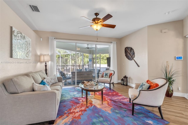 living room with ceiling fan and hardwood / wood-style flooring