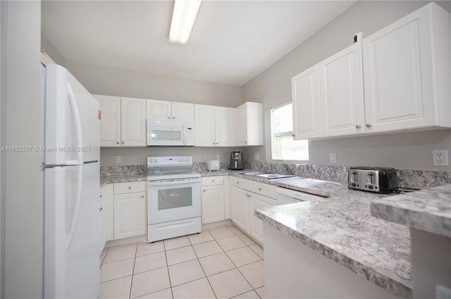 kitchen featuring white appliances, light tile patterned floors, kitchen peninsula, and white cabinets