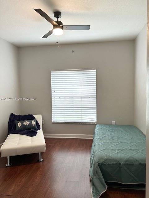 bedroom featuring wood-type flooring and ceiling fan