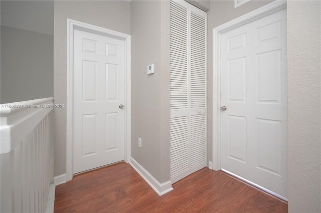 hallway with dark hardwood / wood-style flooring