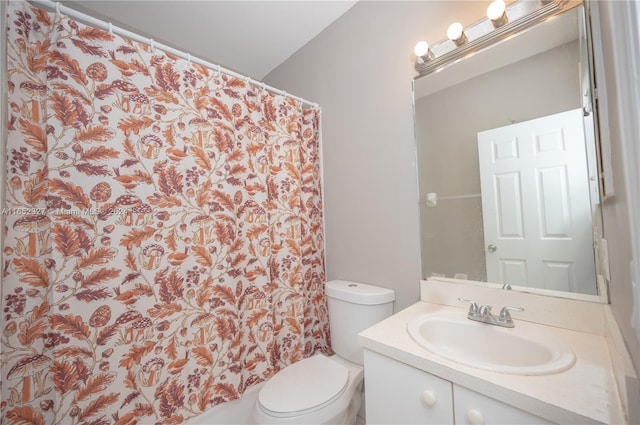 bathroom featuring walk in shower, vanity, and toilet