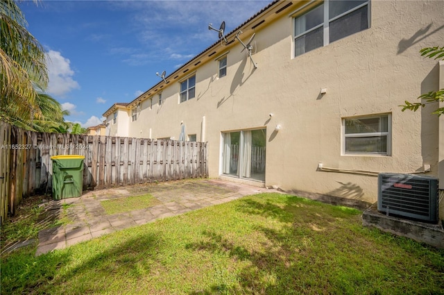 back of house with a patio, cooling unit, and a lawn