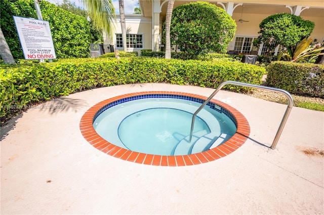 view of swimming pool with a community hot tub