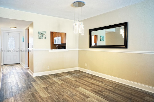 unfurnished room with wood-type flooring