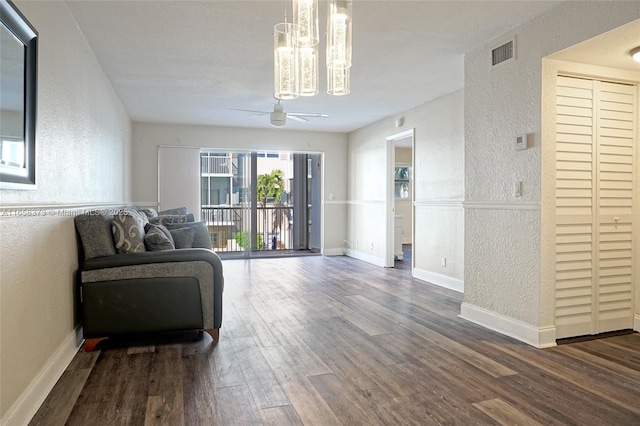 living room with wood-type flooring and ceiling fan