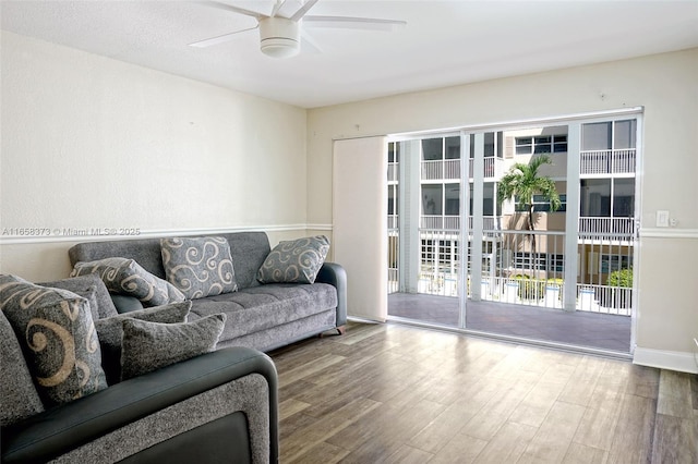 living room featuring hardwood / wood-style flooring and ceiling fan