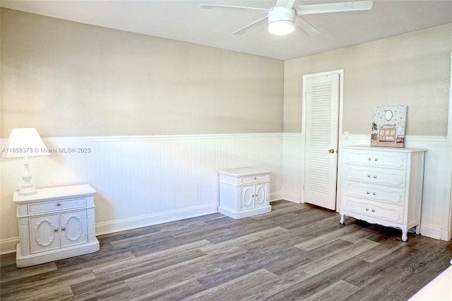 unfurnished bedroom featuring dark hardwood / wood-style flooring, a closet, and ceiling fan