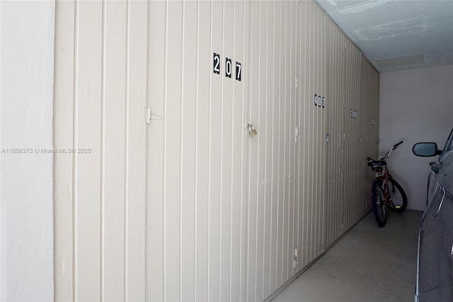 interior space featuring wooden walls and concrete flooring