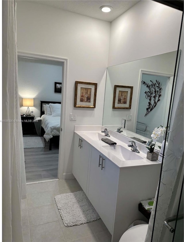 bathroom with vanity, toilet, and tile patterned floors