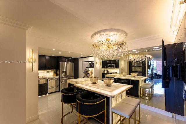 kitchen with crown molding, light tile patterned floors, stainless steel appliances, a kitchen island, and a breakfast bar area