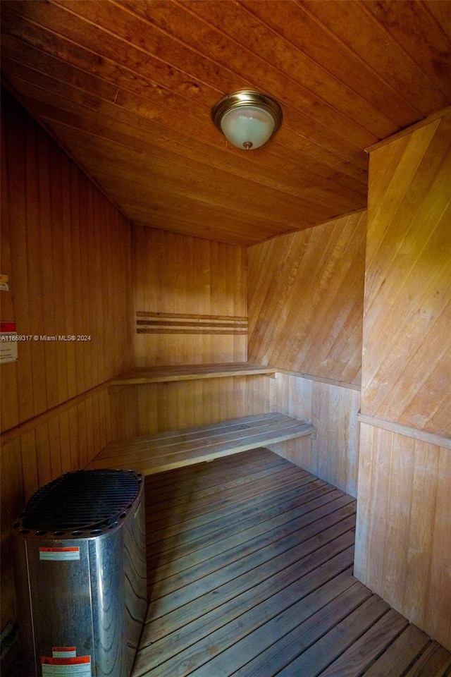 view of sauna with wood walls and wood ceiling