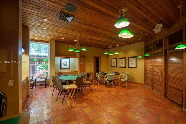 dining space featuring wood ceiling and tile patterned flooring