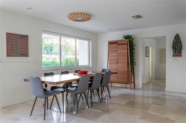 dining room featuring marble finish floor, visible vents, and baseboards