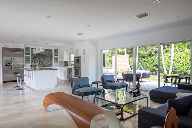 living room featuring recessed lighting and visible vents