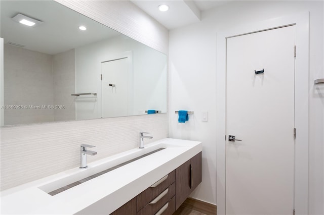 bathroom with recessed lighting, tasteful backsplash, and vanity