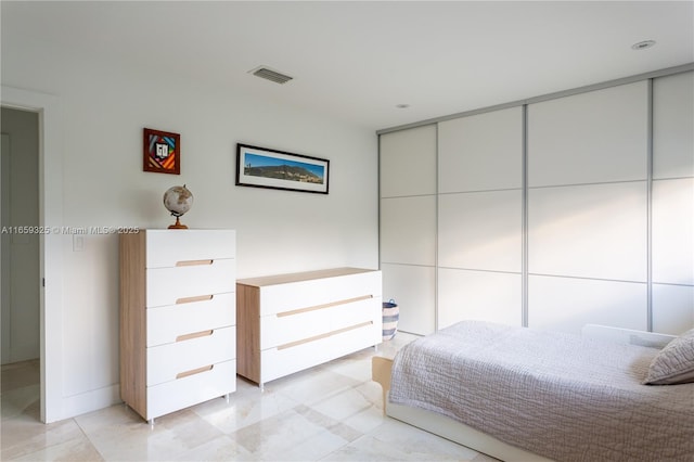 bedroom with a closet and visible vents