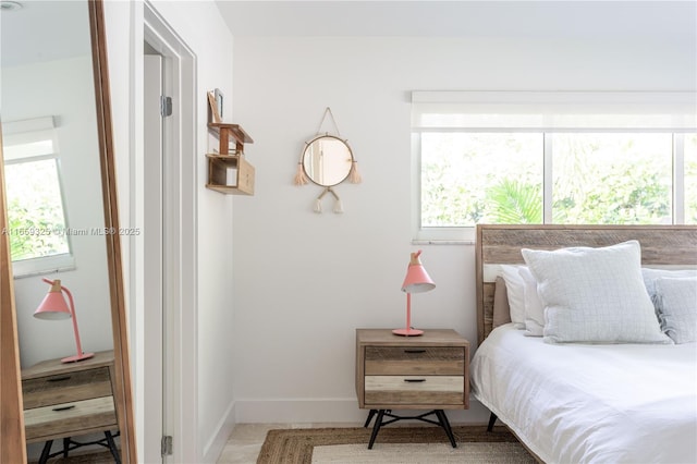 bedroom with multiple windows and baseboards