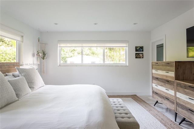 bedroom featuring multiple windows and hardwood / wood-style floors