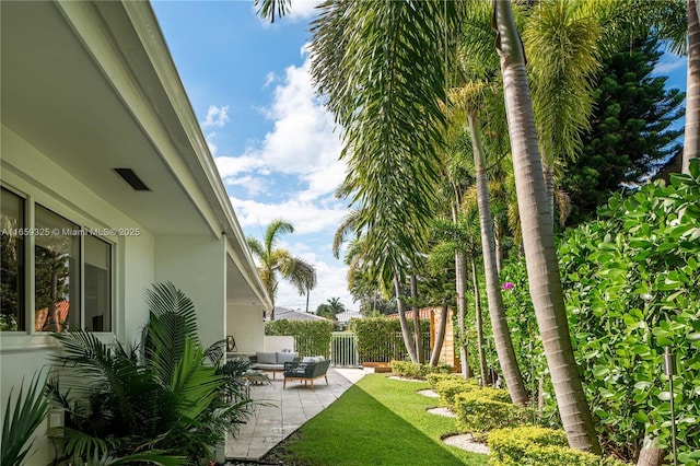 view of yard with a patio, fence, and an outdoor living space