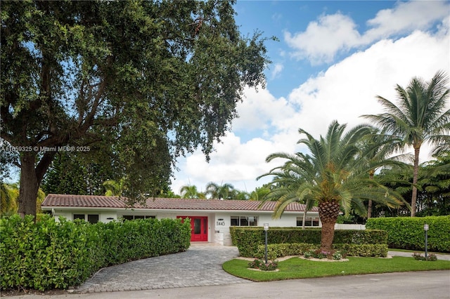 single story home featuring a tile roof and stucco siding