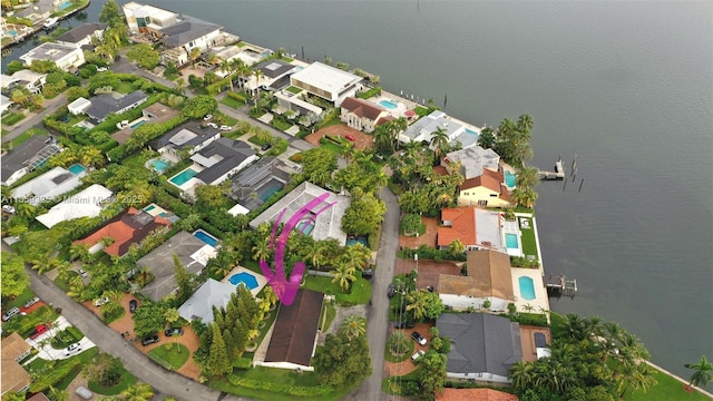 birds eye view of property with a water view and a residential view