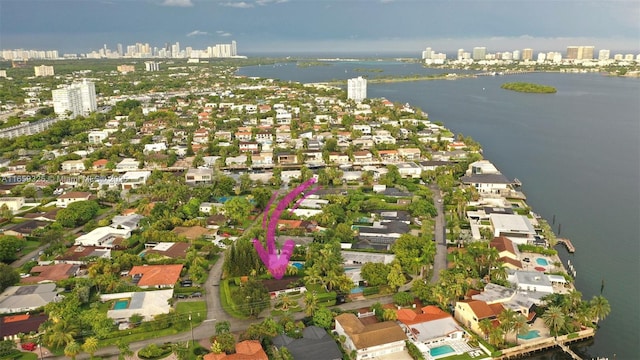 birds eye view of property with a water view and a city view