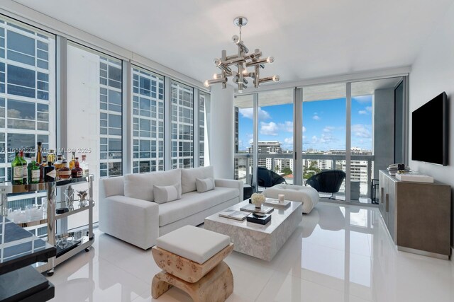 living room featuring light tile patterned floors, a notable chandelier, and expansive windows