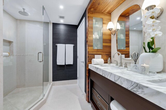 bathroom with walk in shower, wooden walls, and vanity