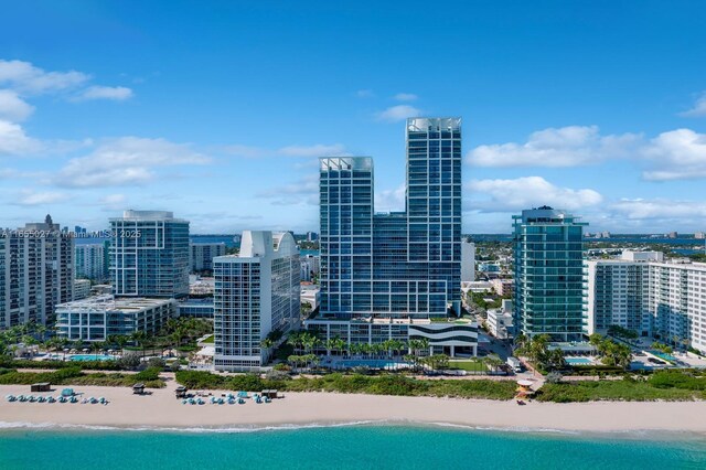 aerial view featuring a view of the beach and a water view