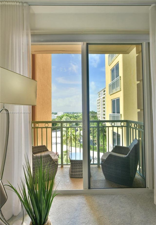 doorway to outside with carpet floors