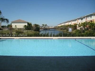 view of pool with a water view