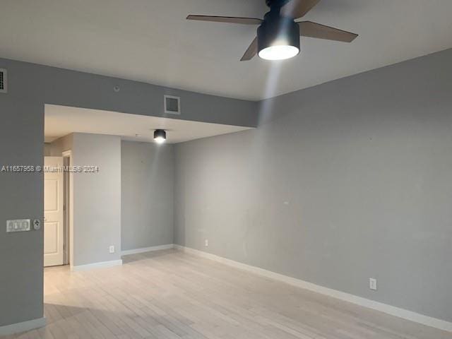 empty room with light hardwood / wood-style flooring and ceiling fan