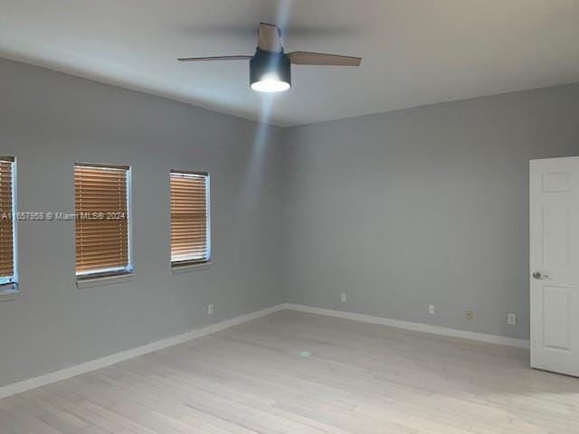 spare room featuring ceiling fan and light hardwood / wood-style flooring