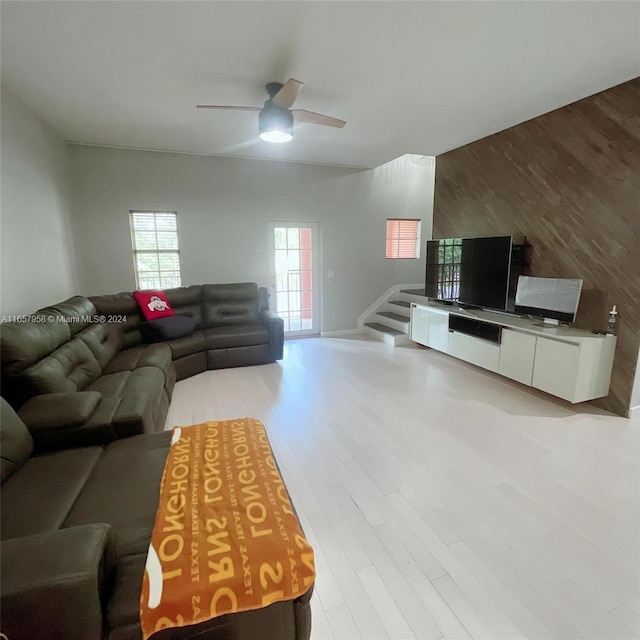 living room with hardwood / wood-style flooring and ceiling fan